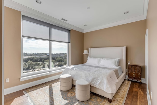 bedroom with hardwood / wood-style floors and crown molding