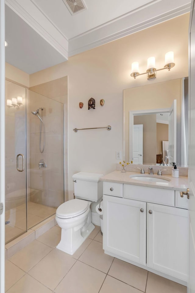 bathroom featuring vanity, ornamental molding, a shower with shower door, tile patterned floors, and toilet