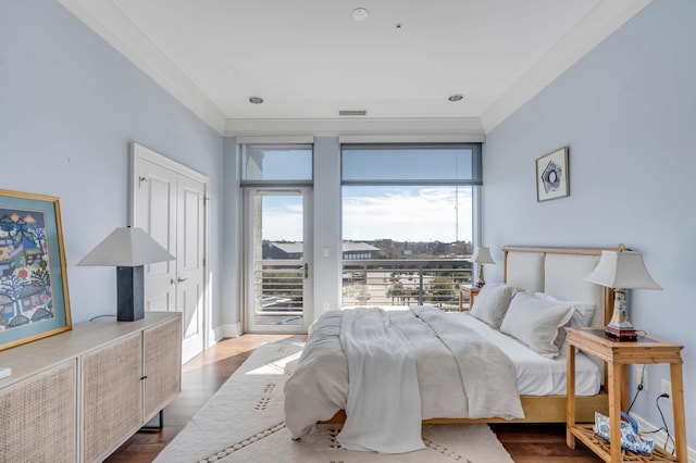 bedroom with crown molding, access to exterior, and hardwood / wood-style floors