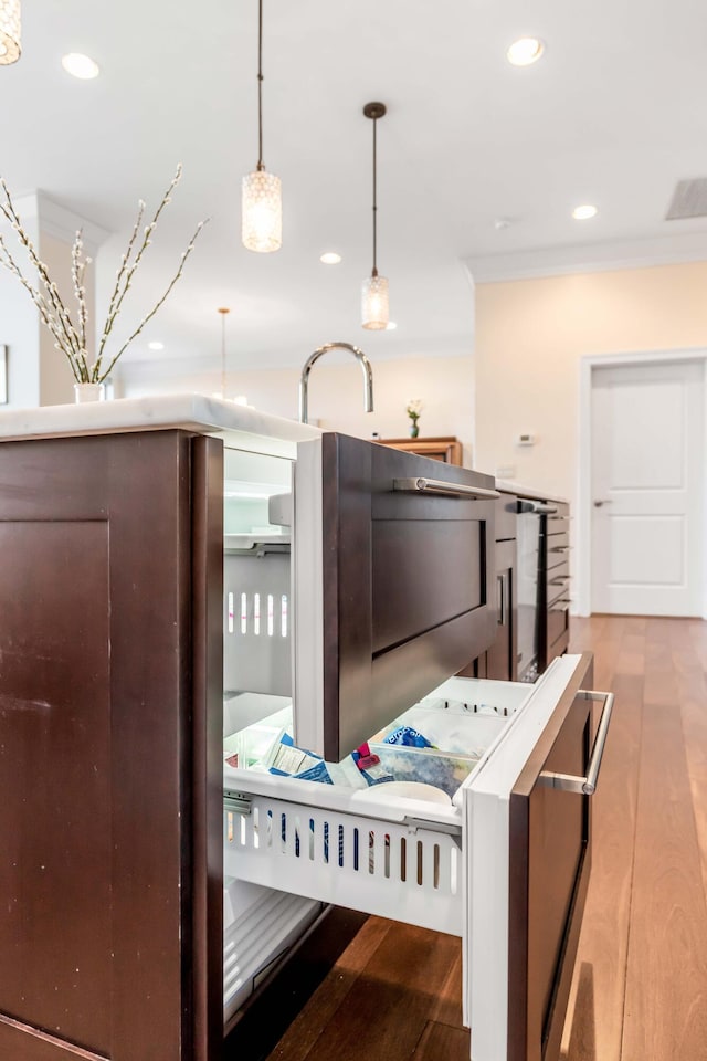 kitchen with pendant lighting and light wood-type flooring