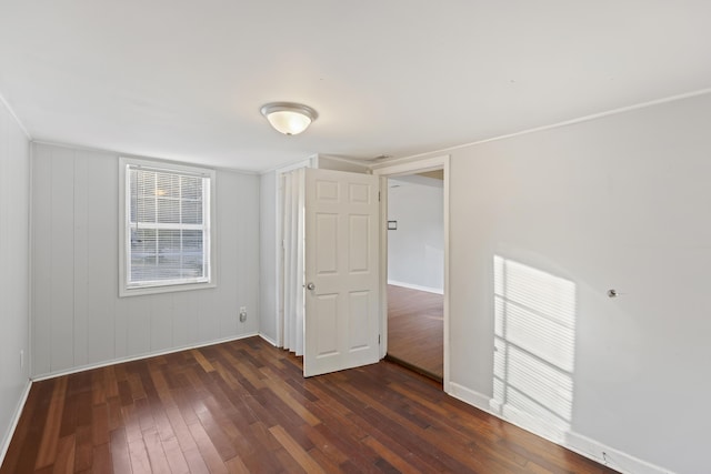 spare room with dark hardwood / wood-style flooring