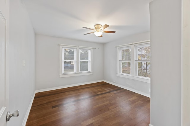 spare room featuring ceiling fan and dark hardwood / wood-style flooring