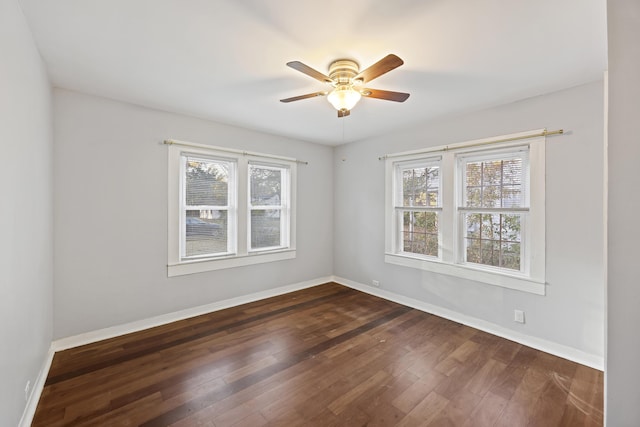 unfurnished room featuring dark hardwood / wood-style floors and ceiling fan