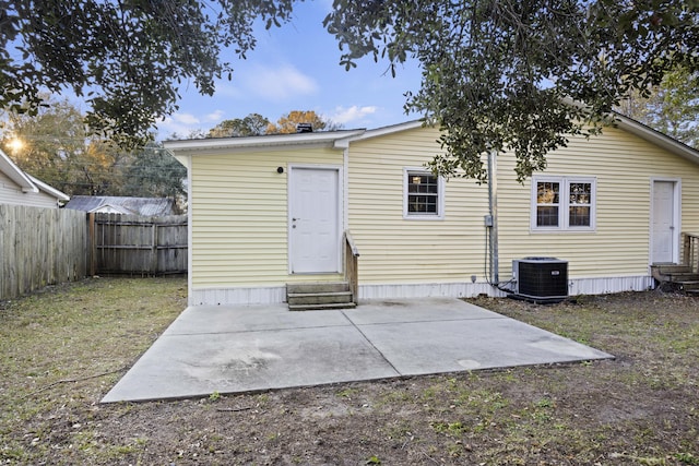 rear view of property featuring cooling unit and a patio