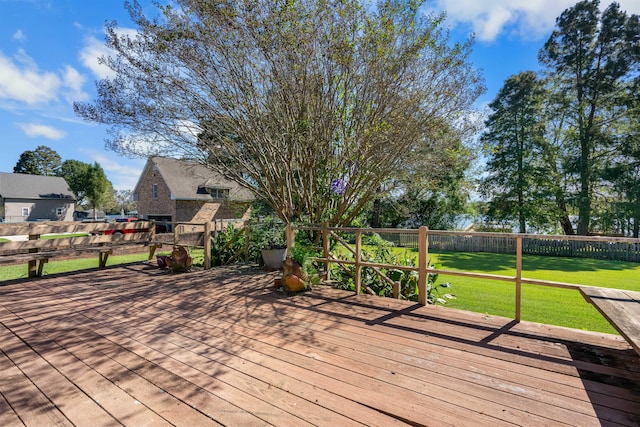 wooden terrace featuring a yard