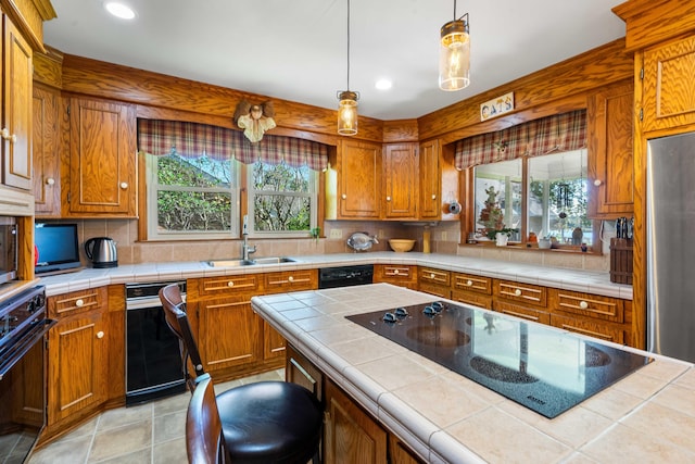 kitchen featuring tile countertops, plenty of natural light, and black appliances