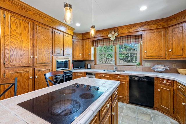 kitchen with black appliances, tile counters, tasteful backsplash, and sink