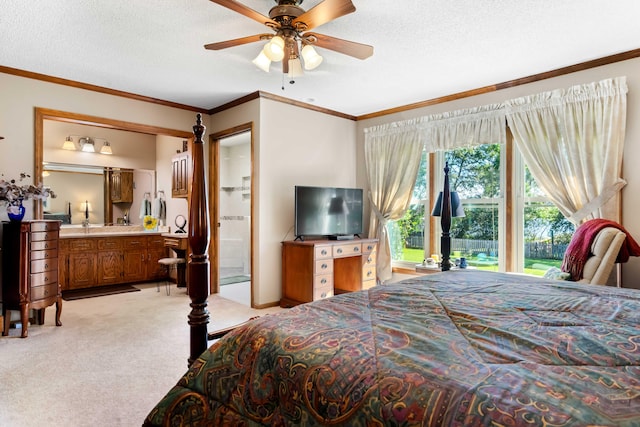 bedroom featuring a textured ceiling, connected bathroom, ceiling fan, and light colored carpet