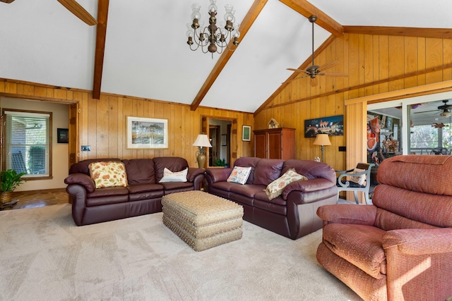 carpeted living room featuring beamed ceiling, ceiling fan with notable chandelier, wood walls, and high vaulted ceiling