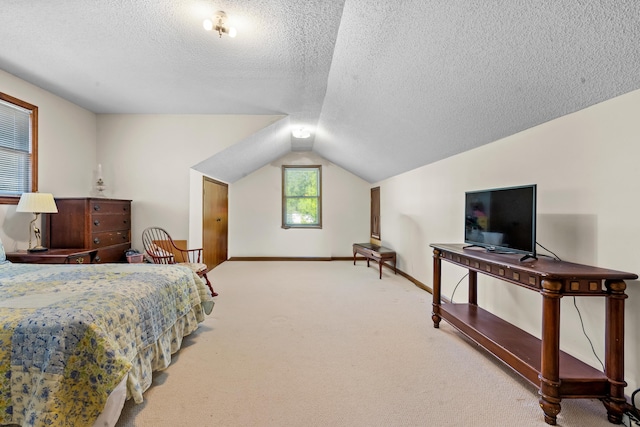 bedroom featuring lofted ceiling, a textured ceiling, and carpet flooring