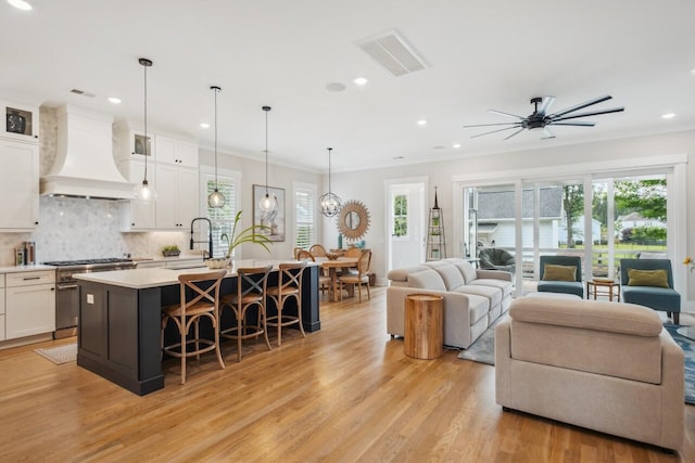 1903 Bolden Dr, Mount Pleasant, SC 29466 - living room featuring light wood-type flooring, recessed lighting, a ceiling fan, and crown molding