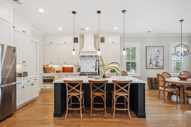 1903 Bolden Dr, Mount Pleasant, SC 29466 - kitchen featuring stainless steel appliances, premium range hood, ornamental molding, backsplash, and light countertops