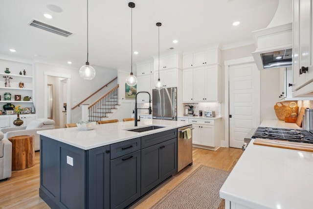 1903 Bolden Dr, Mount Pleasant, SC 29466 - kitchen with appliances with stainless steel finishes, white cabinetry, light wood-style flooring, backsplash, and open floor plan