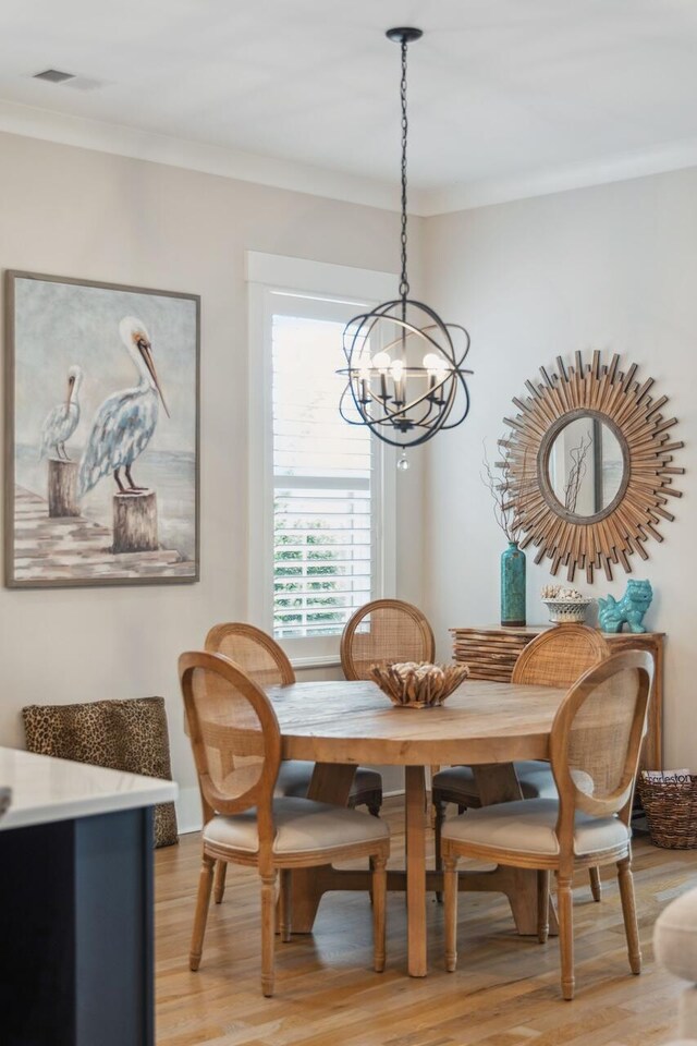 1903 Bolden Dr, Mount Pleasant, SC 29466 - dining space with a chandelier, light wood-type flooring, and crown molding