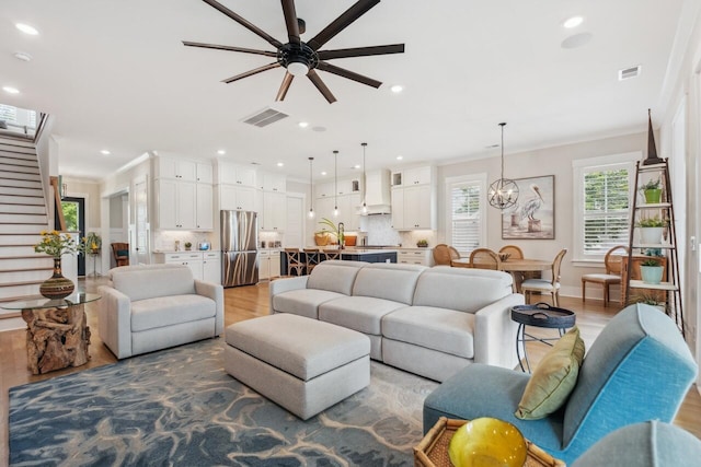 1903 Bolden Dr, Mount Pleasant, SC 29466 - living room with wood finished floors, a ceiling fan, a chandelier, recessed lighting, and crown molding