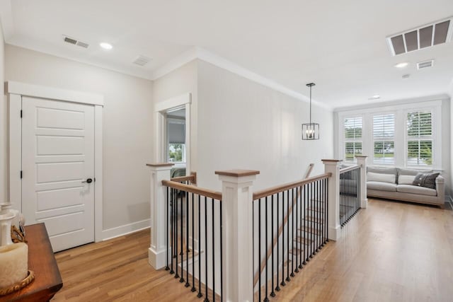 1903 Bolden Dr, Mount Pleasant, SC 29466 - hallway with an upstairs landing, light wood-style floors, ornamental molding, and recessed lighting