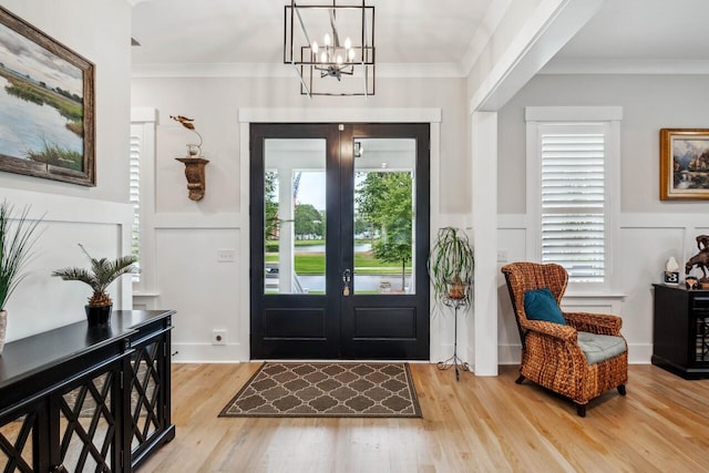1903 Bolden Dr, Mount Pleasant, SC 29466 - entryway featuring a decorative wall, light wood finished floors, a chandelier, a wainscoted wall, and crown molding