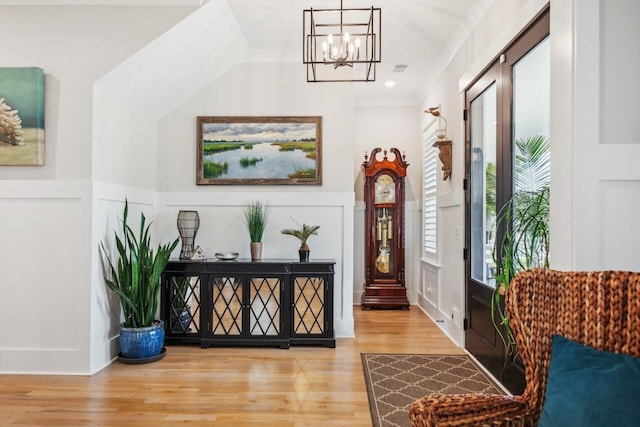 1903 Bolden Dr, Mount Pleasant, SC 29466 - entryway with a chandelier, a decorative wall, wood finished floors, and a wainscoted wall