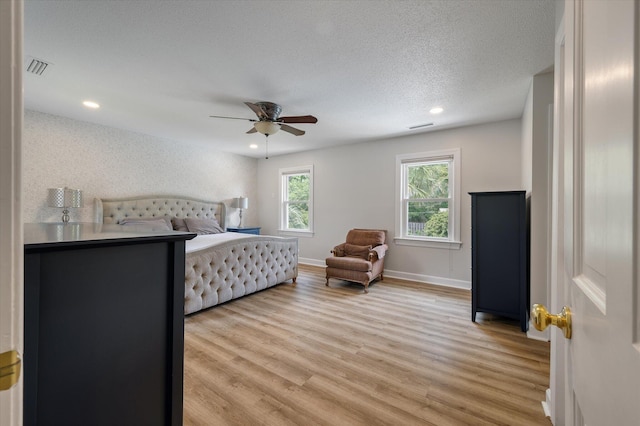 bedroom featuring light wood-style flooring, recessed lighting, a ceiling fan, baseboards, and a textured ceiling