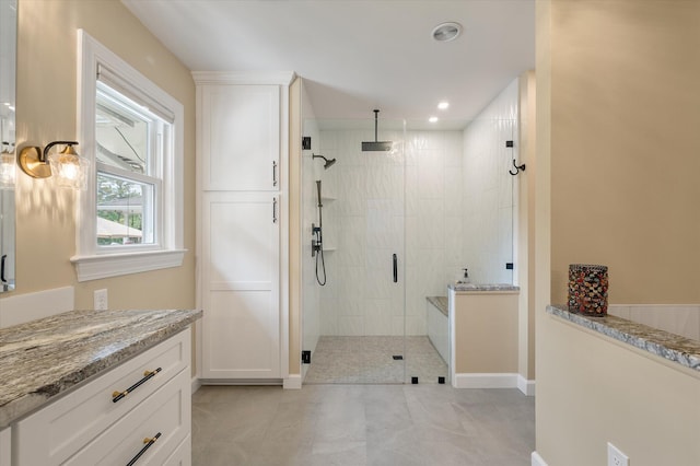 full bathroom featuring a stall shower, recessed lighting, baseboards, tile patterned floors, and vanity