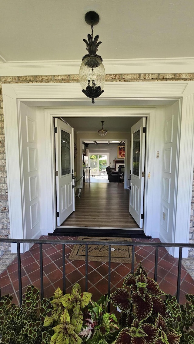 view of exterior entry featuring covered porch