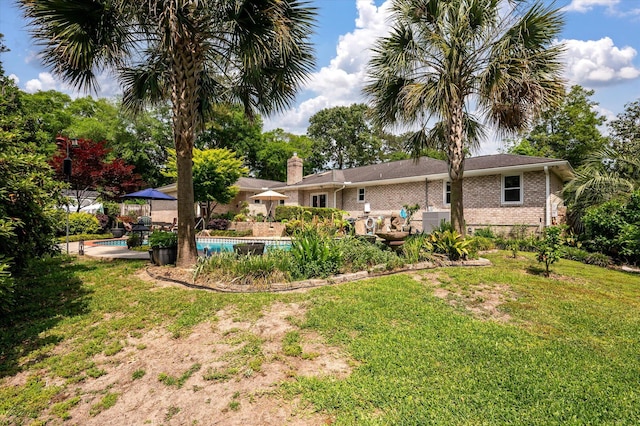 view of grassy yard featuring an outdoor pool