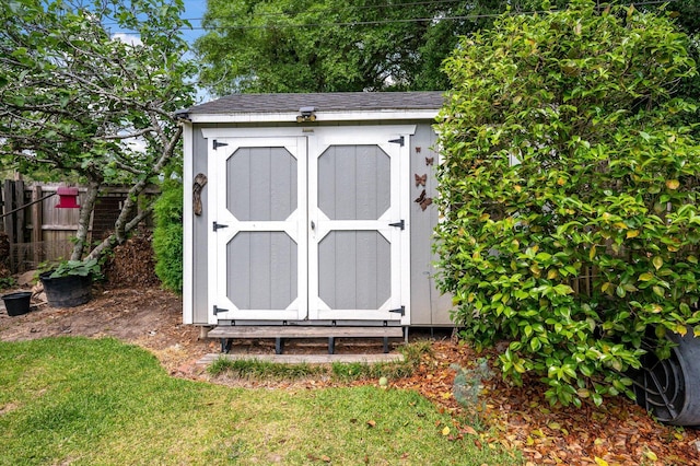 view of shed with fence