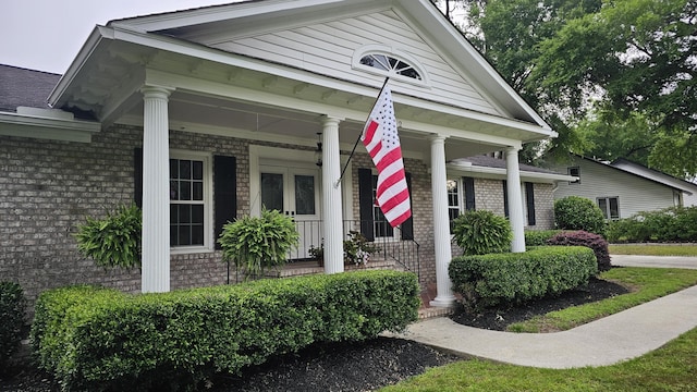 view of front of property featuring brick siding and a porch