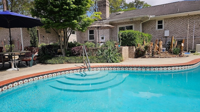 outdoor pool featuring a patio area