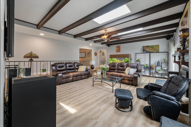 living area with beamed ceiling, wood finished floors, ceiling fan, and recessed lighting