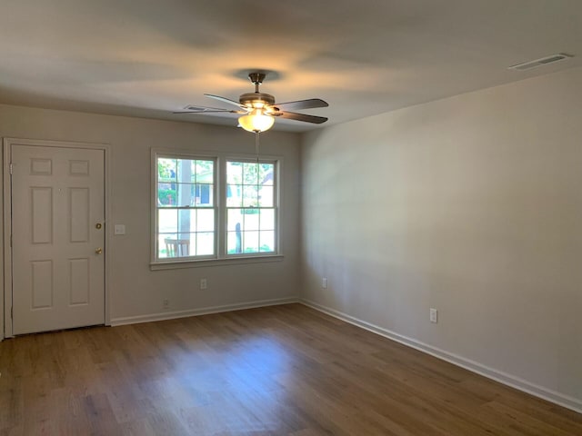 entryway featuring visible vents, ceiling fan, baseboards, and wood finished floors