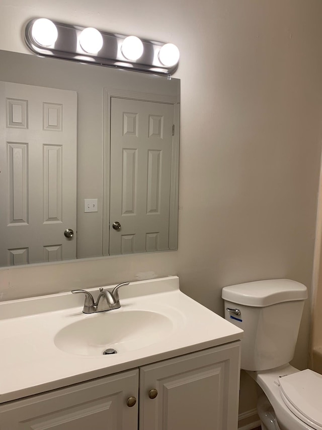 bathroom featuring toilet and vanity