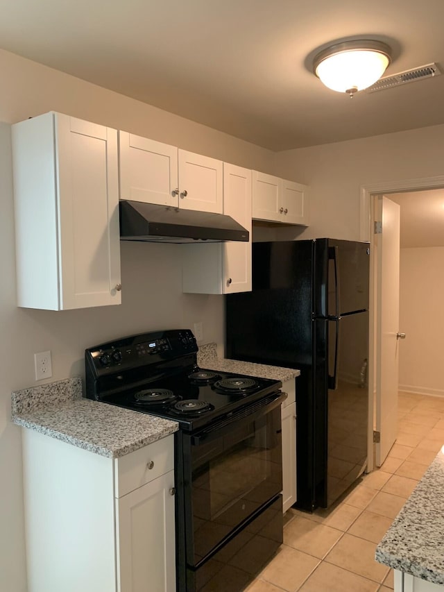 kitchen with visible vents, white cabinets, light stone counters, black range with electric stovetop, and under cabinet range hood