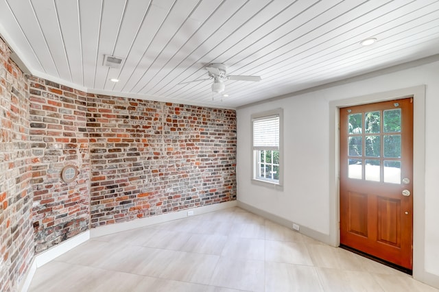 tiled spare room with brick wall, a healthy amount of sunlight, and wood ceiling