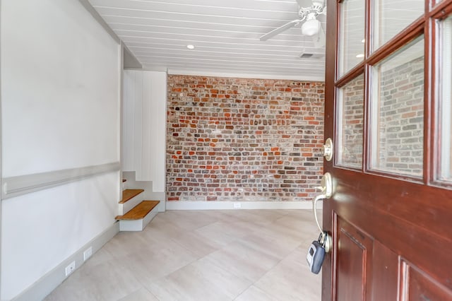 tiled foyer with brick wall and ceiling fan