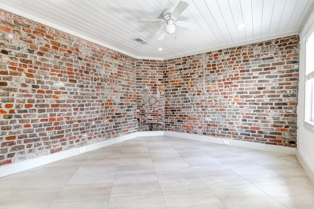 tiled spare room with wood ceiling, ceiling fan, brick wall, and ornamental molding