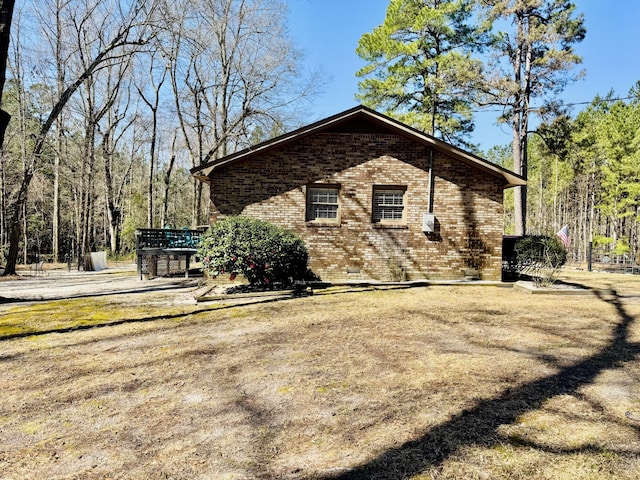 view of side of home with brick siding