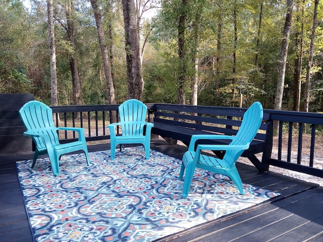 wooden deck with a view of trees