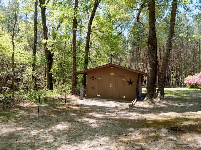 view of outbuilding featuring an outbuilding and a wooded view