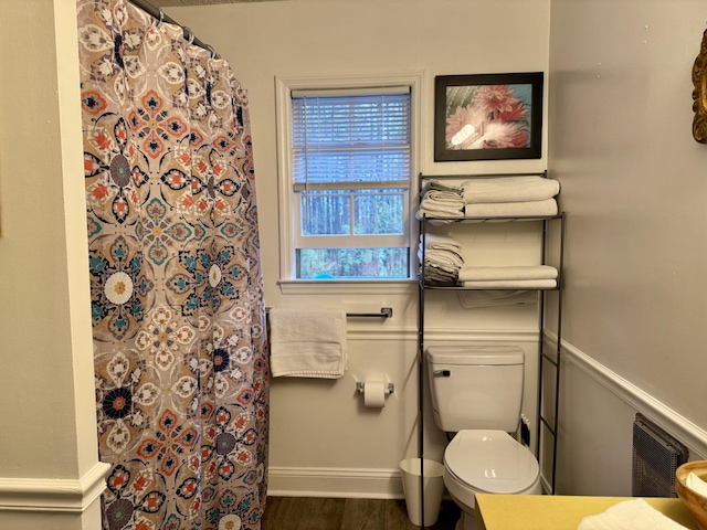 full bath with a shower with shower curtain, baseboards, toilet, and wood finished floors