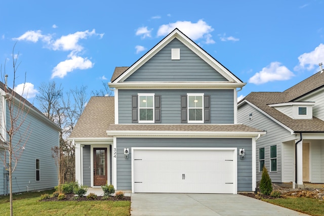 traditional-style house with an attached garage, driveway, and a shingled roof