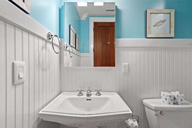 6002 Green Dolphin Way, Kiawah Island, SC 29455 - half bath with a wainscoted wall, toilet, and a sink