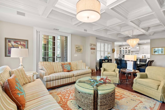 6002 Green Dolphin Way, Kiawah Island, SC 29455 - living room with coffered ceiling, light wood finished floors, a chandelier, beamed ceiling, and crown molding