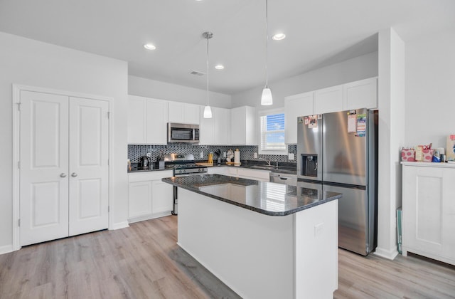 kitchen featuring stainless steel appliances, light wood-style flooring, decorative backsplash, white cabinets, and recessed lighting