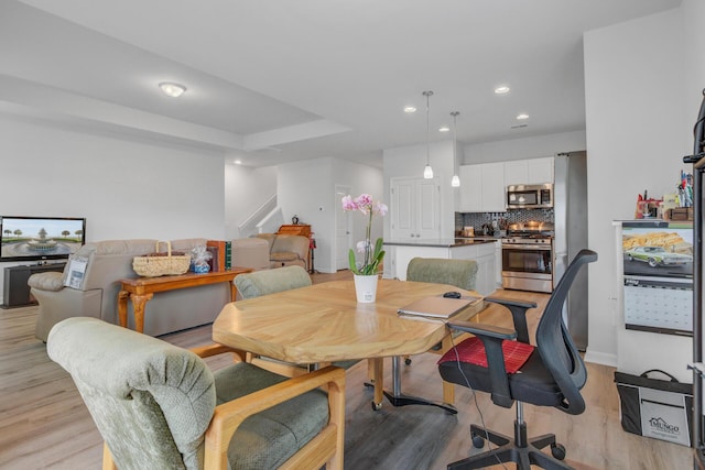 dining room with light wood-style floors, stairs, recessed lighting, and baseboards
