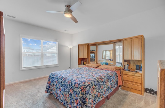 bedroom featuring light carpet, ceiling fan, and baseboards