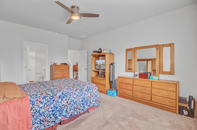 bedroom featuring carpet, ceiling fan, and ensuite bath