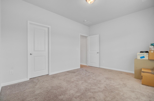unfurnished bedroom with carpet floors and baseboards