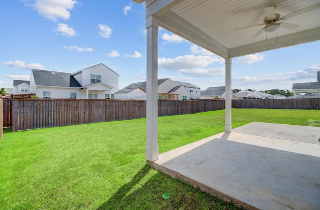 view of yard with a residential view, ceiling fan, and a patio area
