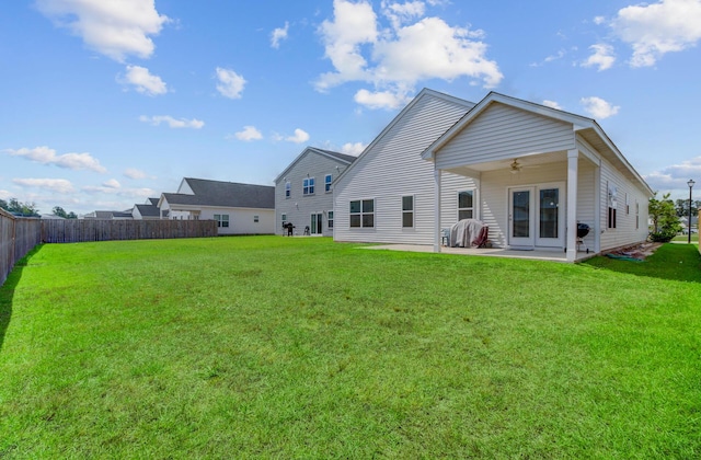 rear view of house featuring ceiling fan, a patio area, and french doors